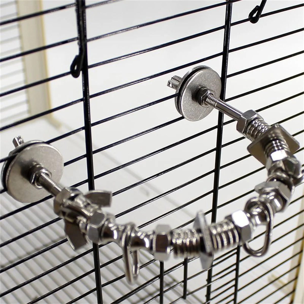 House of parrots & aviaries stainless steel puzzle perch and chew toy installed on a black wire bird cage